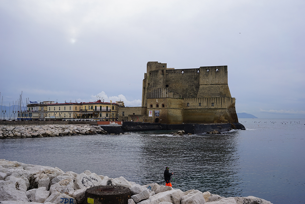 An angler fishing in the harbour of Naples, Italy — a life lived with the sea