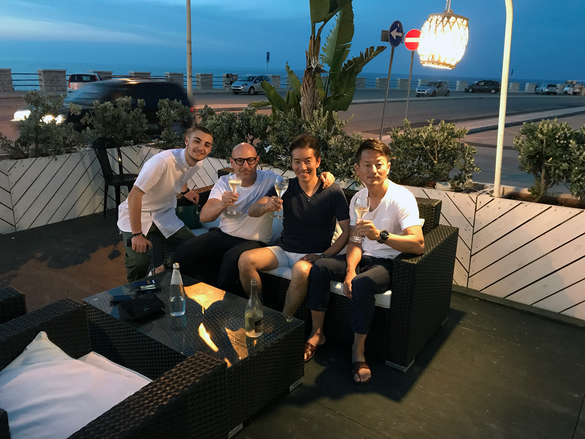 Dusk with close friends on a seaside terrace in Italy